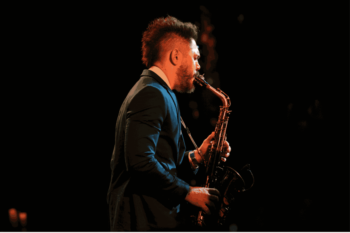 man plays saxophone on stage