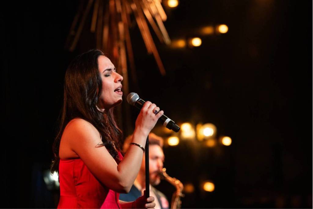 A jazz singer performing on stage at The Jazz Room