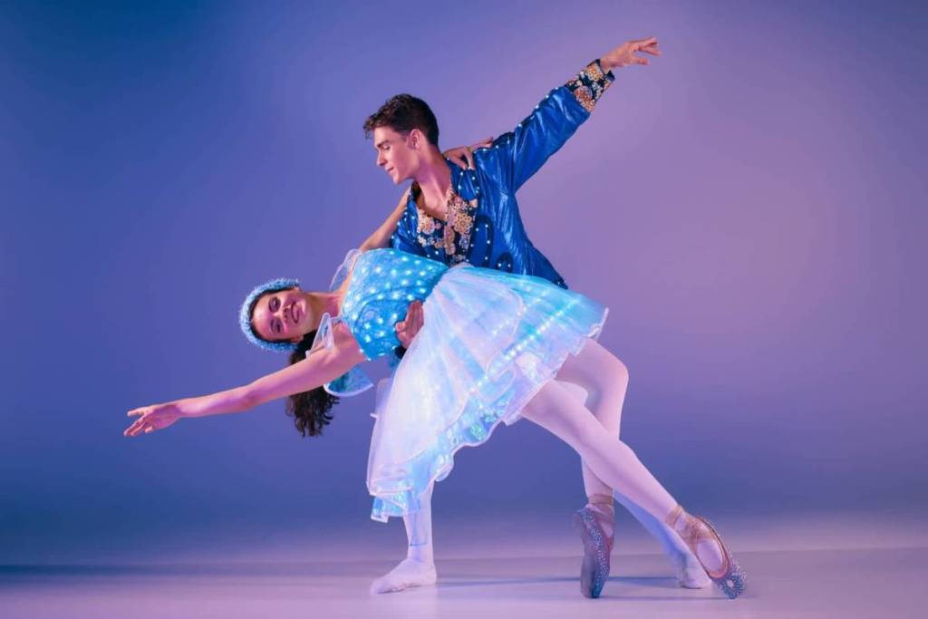 Two dancers in fibre-optic costumes dance at Ballet of Lights.