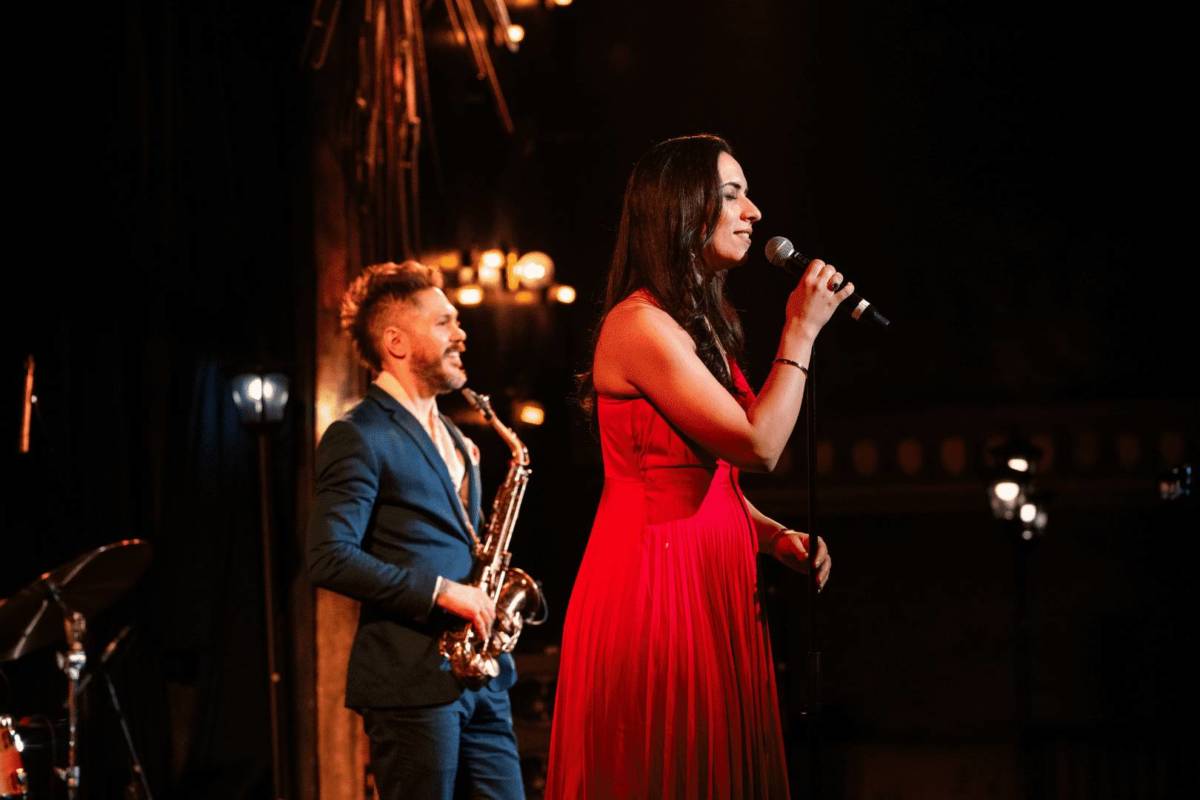 woman sings in long red dress as part of jazz room