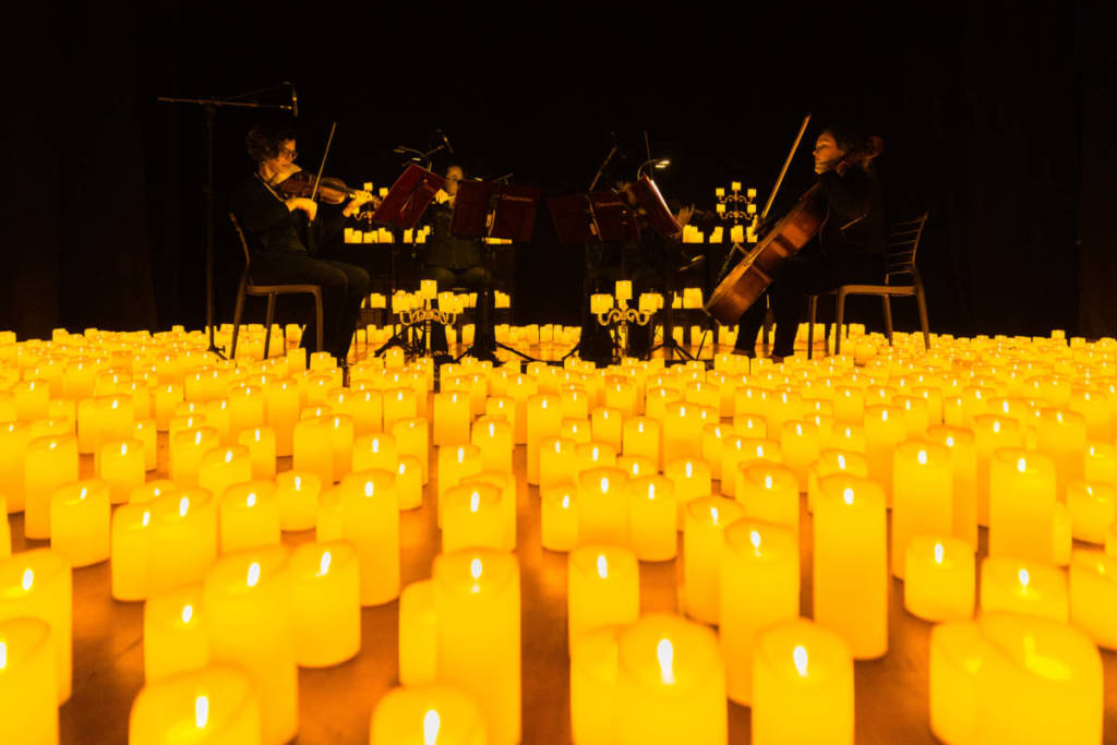 A string quartet performing amid a sea of candles at a Candlelight concert