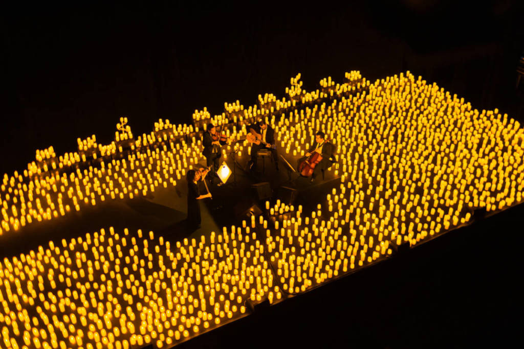 A string quartet performing amid a sea of candles during a Candlelight concert
