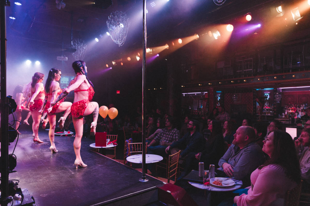 Cabaret dancers performing on stage.