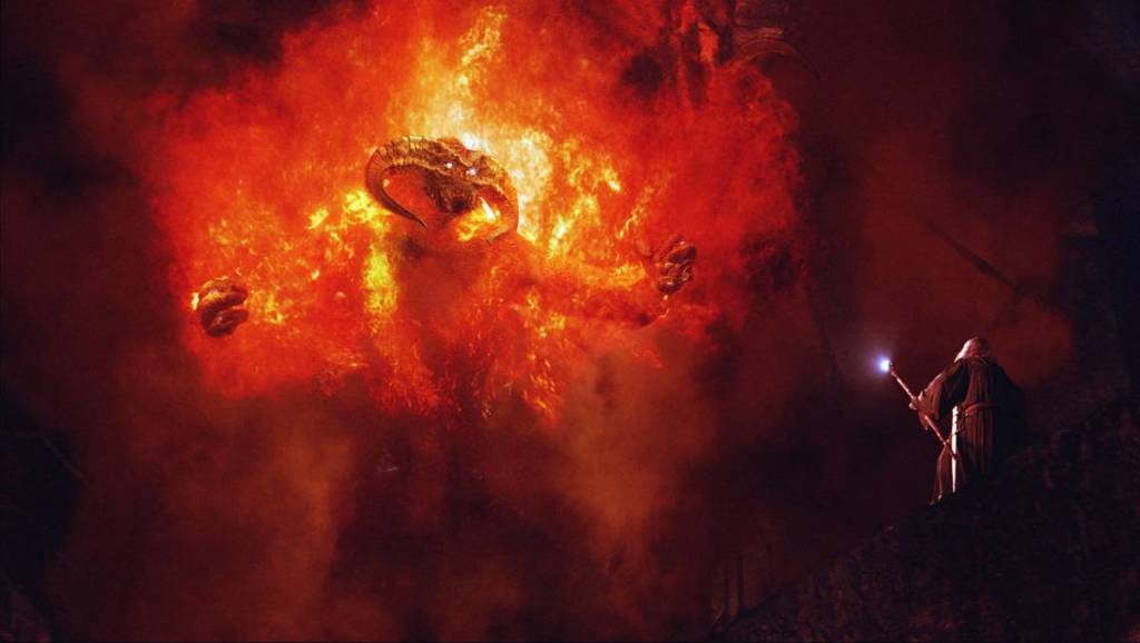 balrog and gandalf face off, still taken from the lord of the rings: the fellowship of the ring