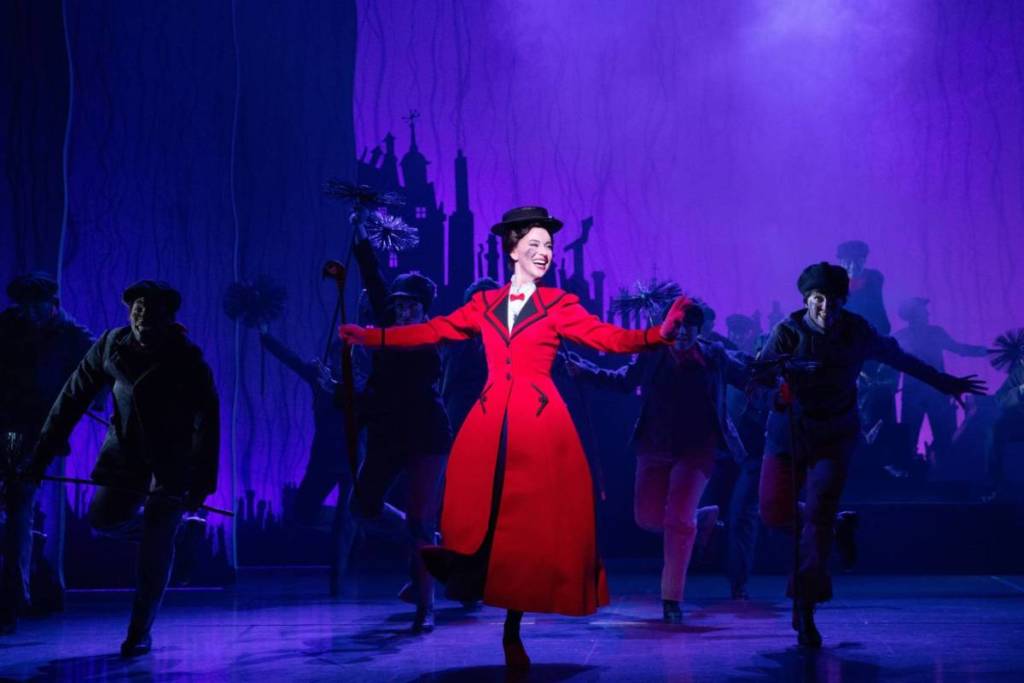 Mary Poppins dancing alongside the famed chimney sweepers on stage