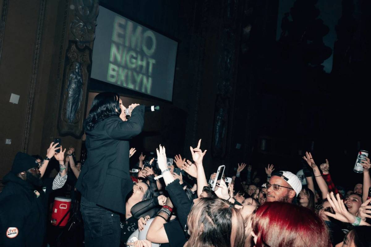 crowd sings along as man sings on stage at emo night brooklyn