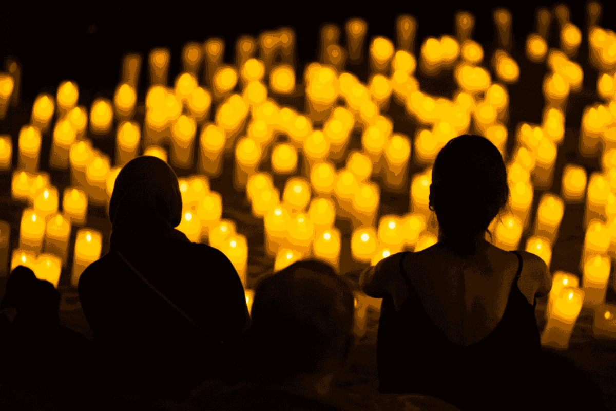 photo shows room filled with glow of candles at a candlelight concert
