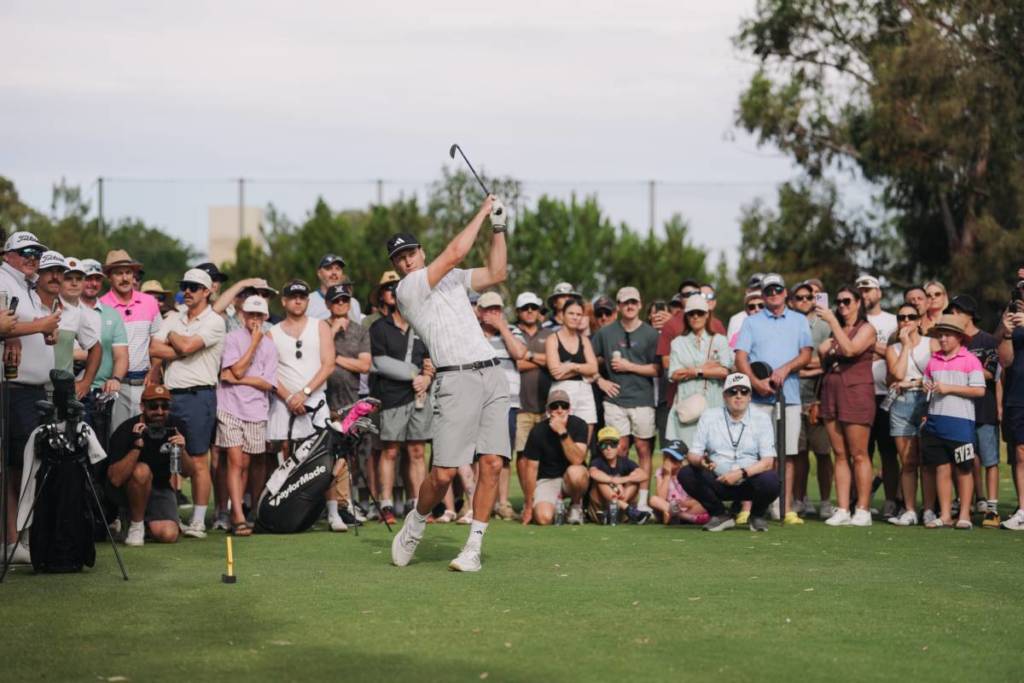 A player at Blitz Golf watched by an audience on the field