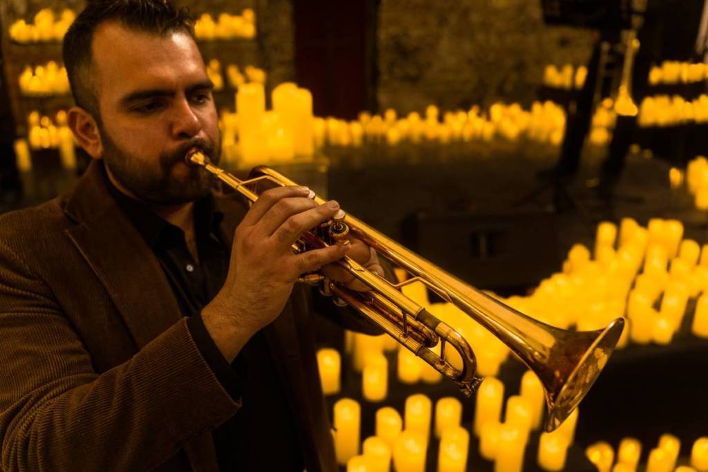 A musician playing the trumpet at a Candlelight concert