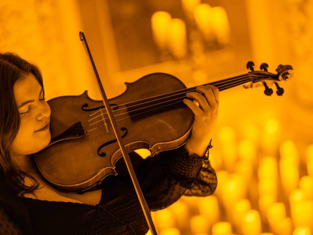 A musician playing the violin at a Candlelight concert in Liverpool