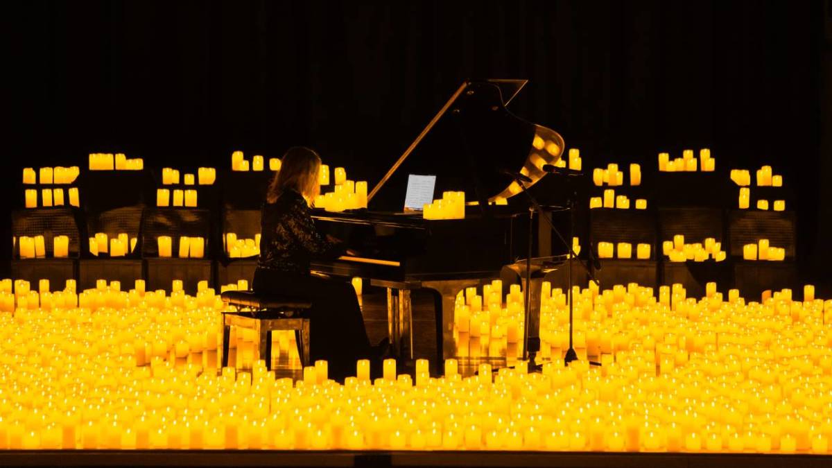 A pianist performing at a Candlelight concert amid a sea of candles