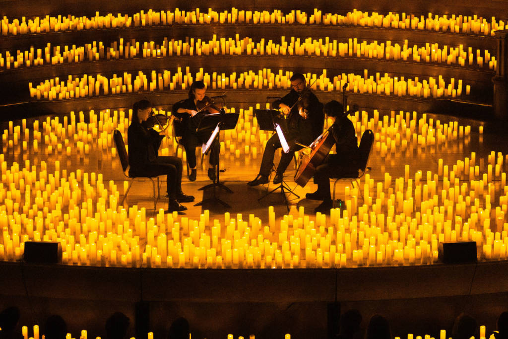 a string quartet performing by candlelight