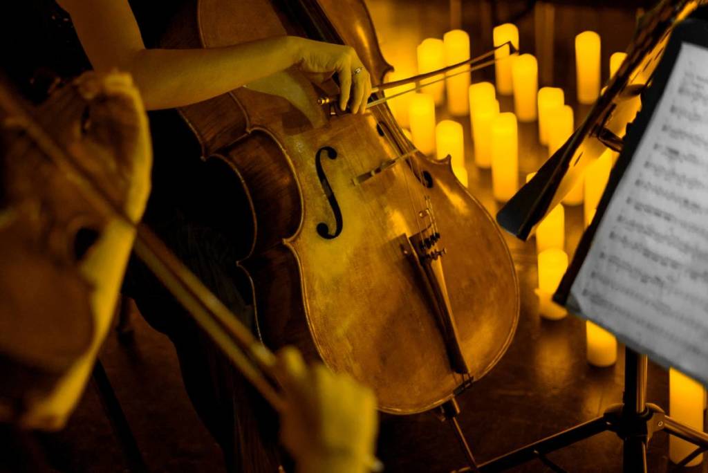 A cello player performing by candlelight