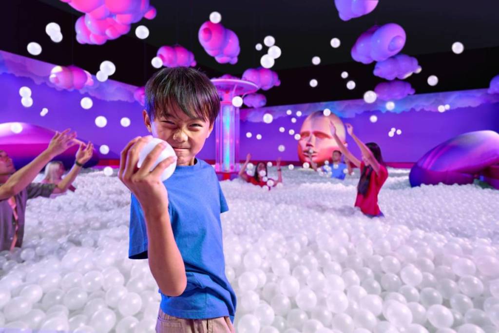 A family playfully frolicking within Bubble Planet Hong Kong's giant 