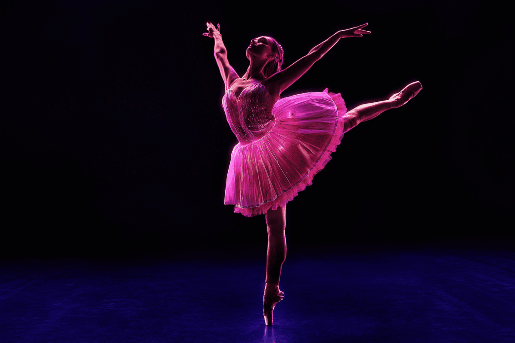 A ballerina in a pink dress performs at Ballet of Lights.