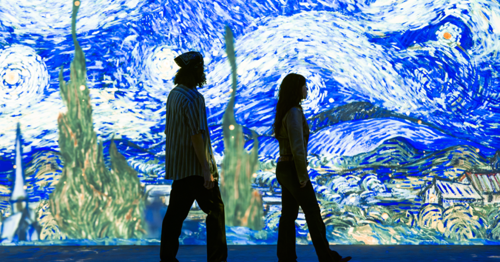 A couple walking inside the Van Gogh Exhibition