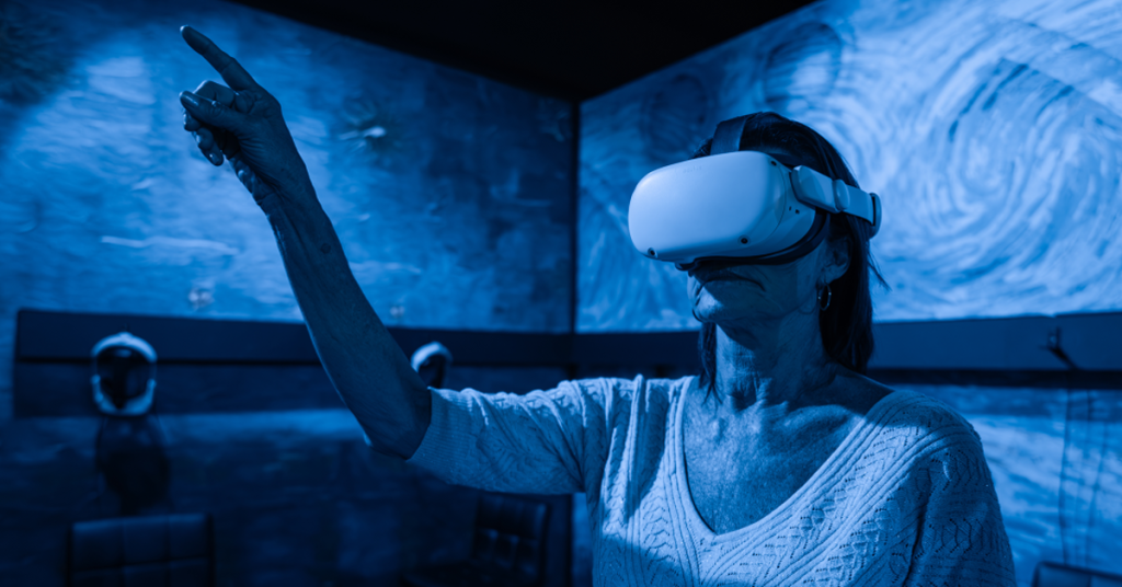A woman wearing a VR headset at Van Gogh Exhibition: The Immersive Experience