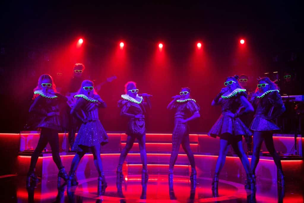 the cast of six wearing neon sunglasses