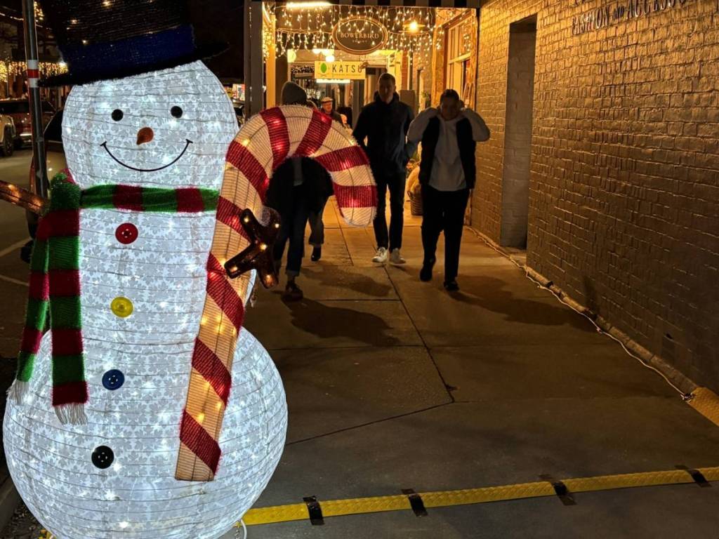 snowman light installation on a street in Bright at night
