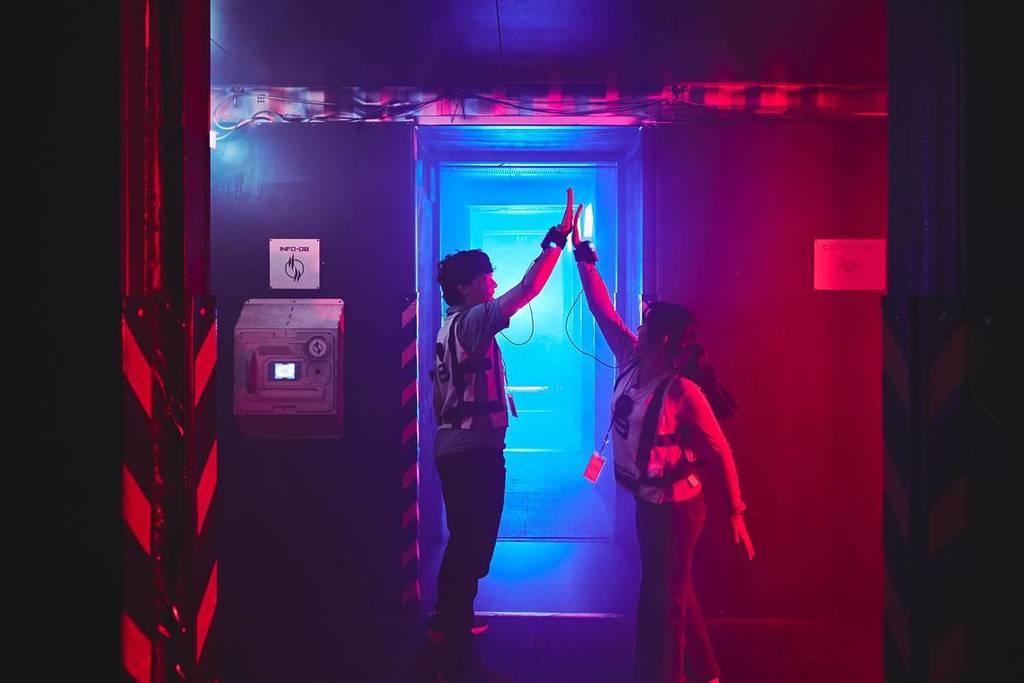 Two players high-fiving at Saboteurs, best things to do this Christmas