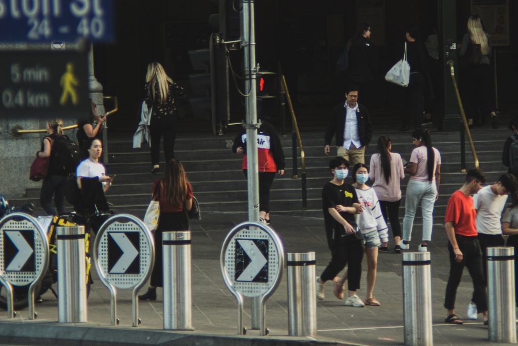 people wearing masks leaving Flinders Street Station