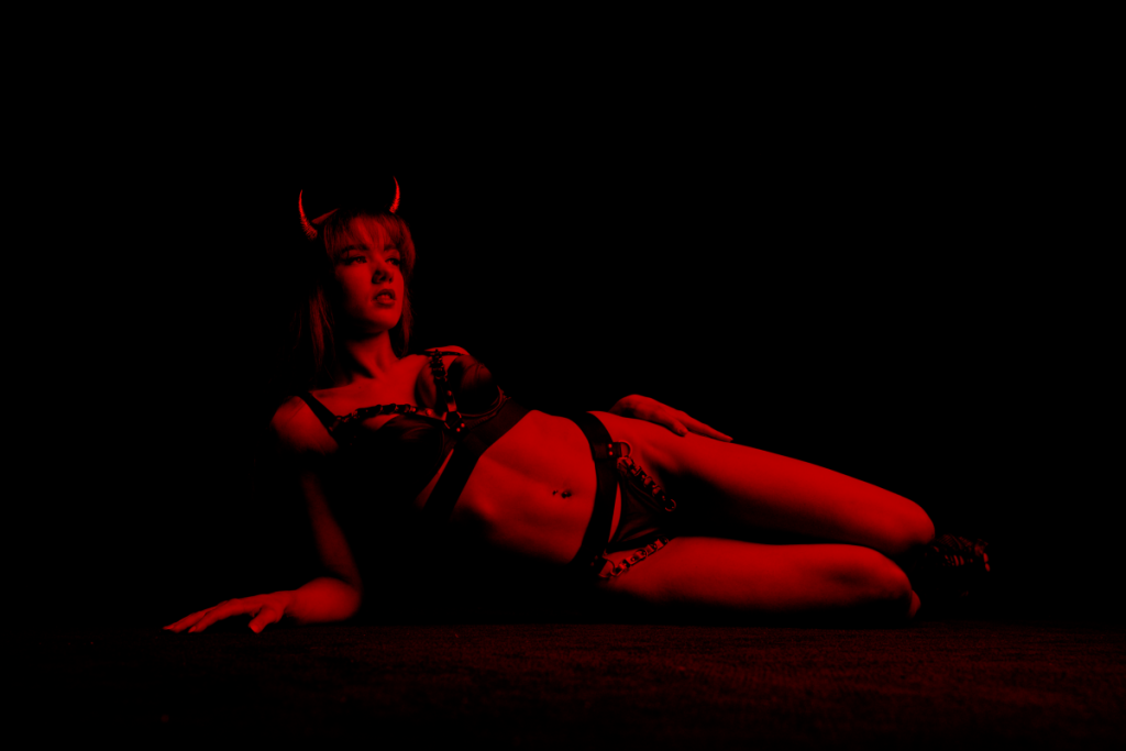performer at VIVA lying on side and wearing devil horns