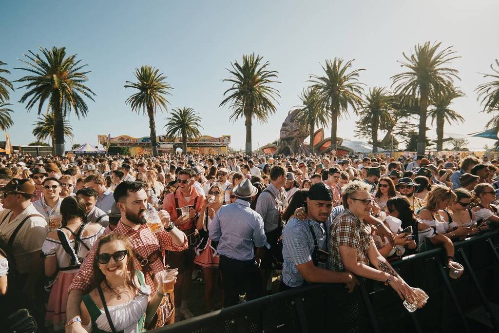 crowds watching something on stage at Oktoberfest in the Gardens