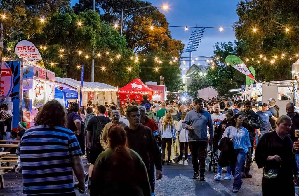 crowds moving past food trucks at Frankston's Christmas Festival