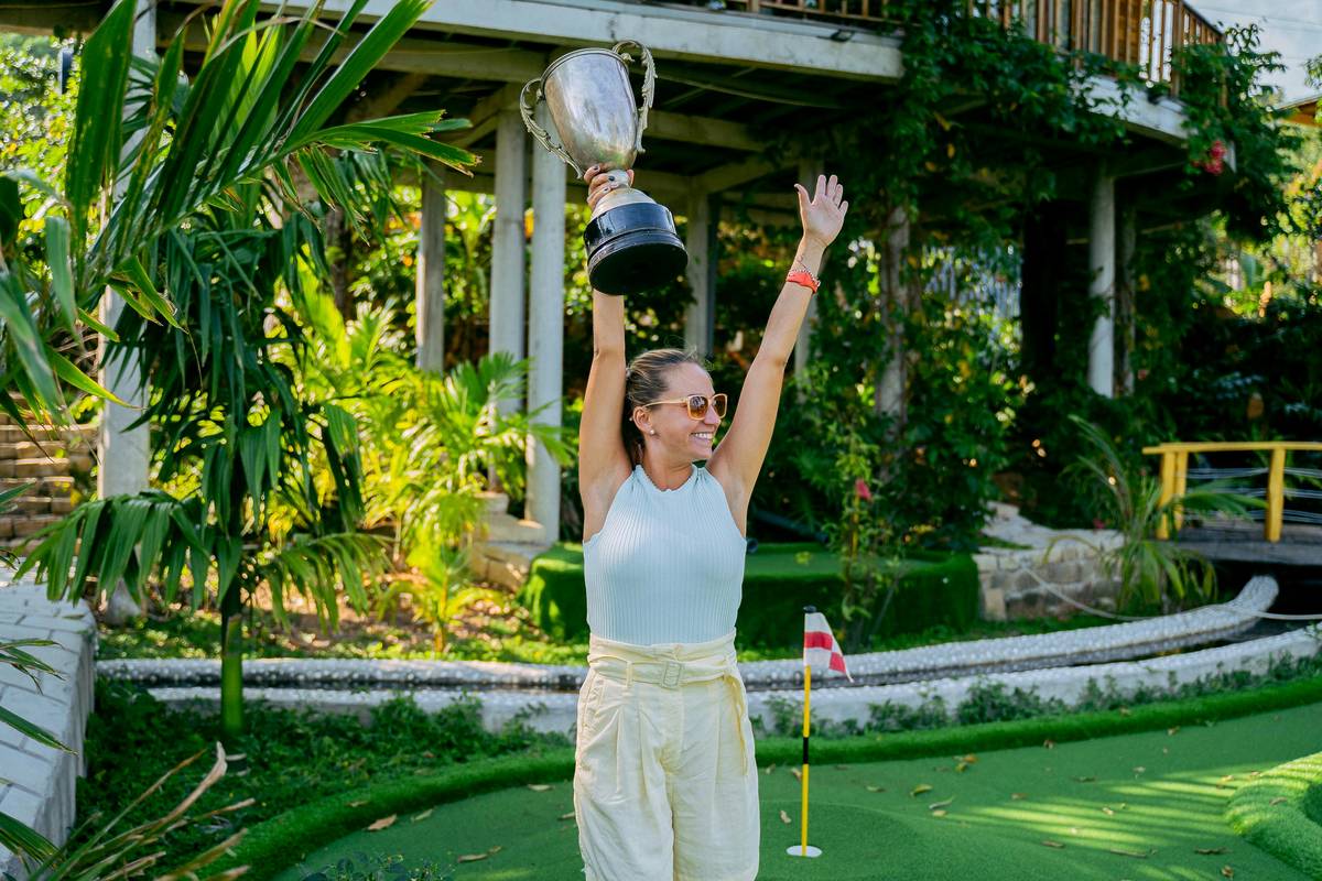 women holds trophy at mini gold center