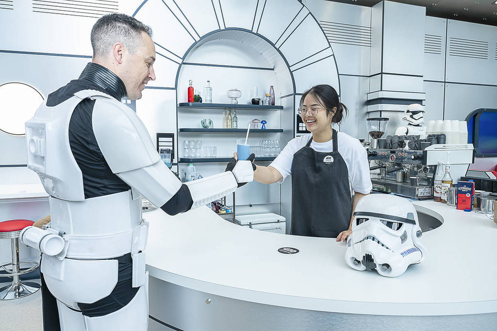 woman serving stormtrooper blue milk at Star Wars Galactic Cafe