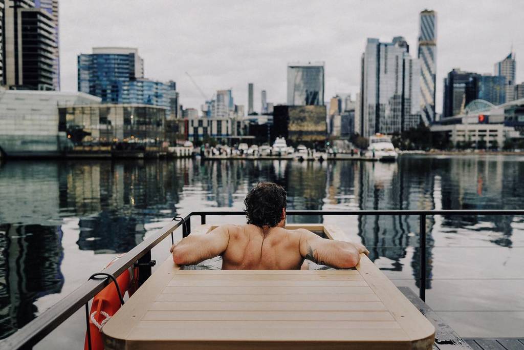 man in the cold plunge on Sauna Boat Melbourne