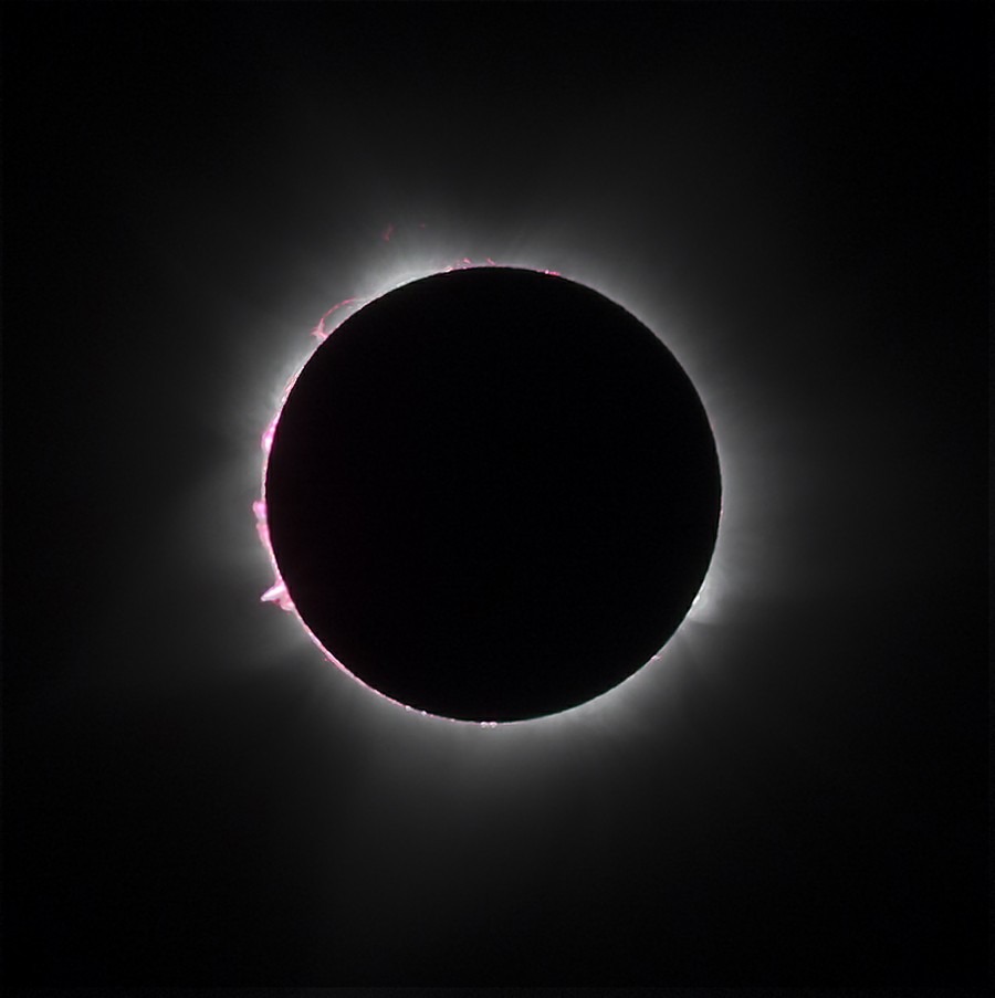 the edges of the sun peeking out from behind a dark circle