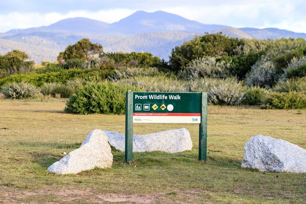 entrance sign for Prom Wildlife Walk with mountain in background