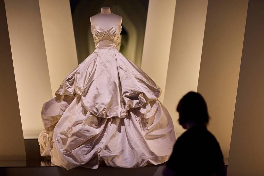 visitor looking at wedding dress used in Sex and the City in Westwood Kawakubo exhibition