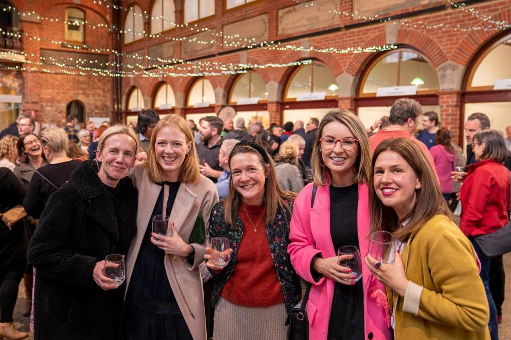 women holding wine glasses at Red Series event