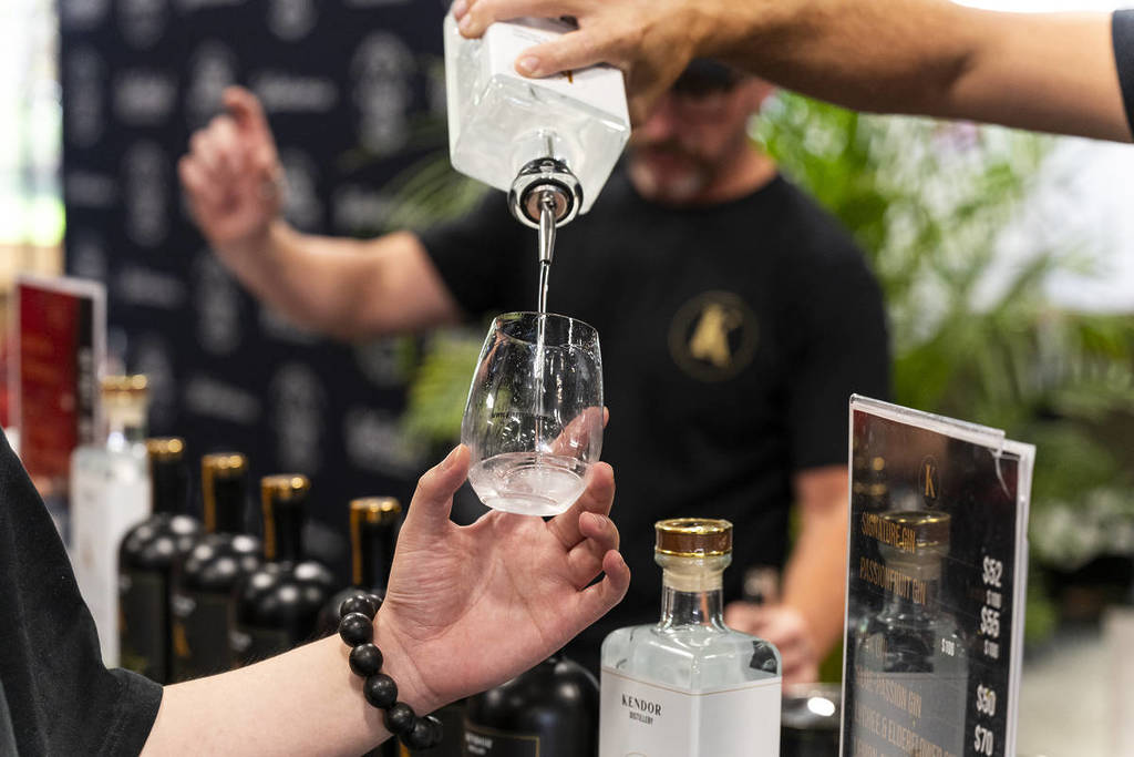 bartender pouring spirit into glass