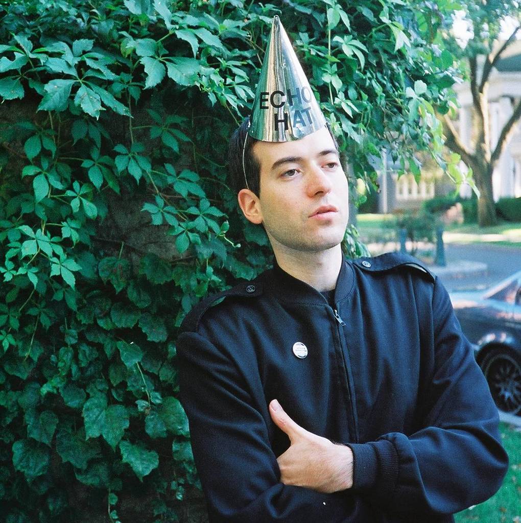 hiphop artist EDAN wearing a party hat that says 'echo hat'