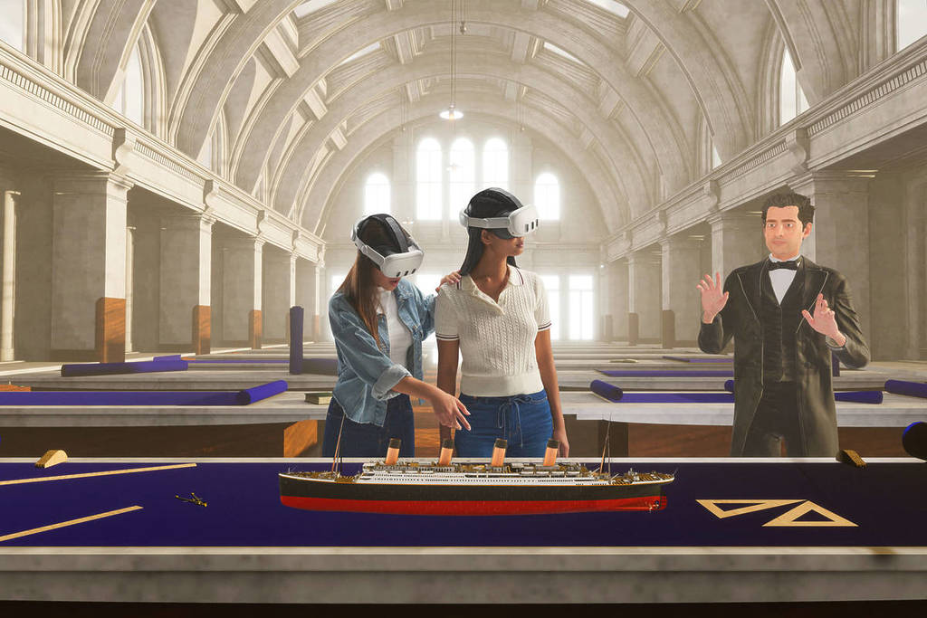Two young women stand with a virtual guide and observe a model of the Titanic. The guide appears to be teaching them about the history of the Titanic.