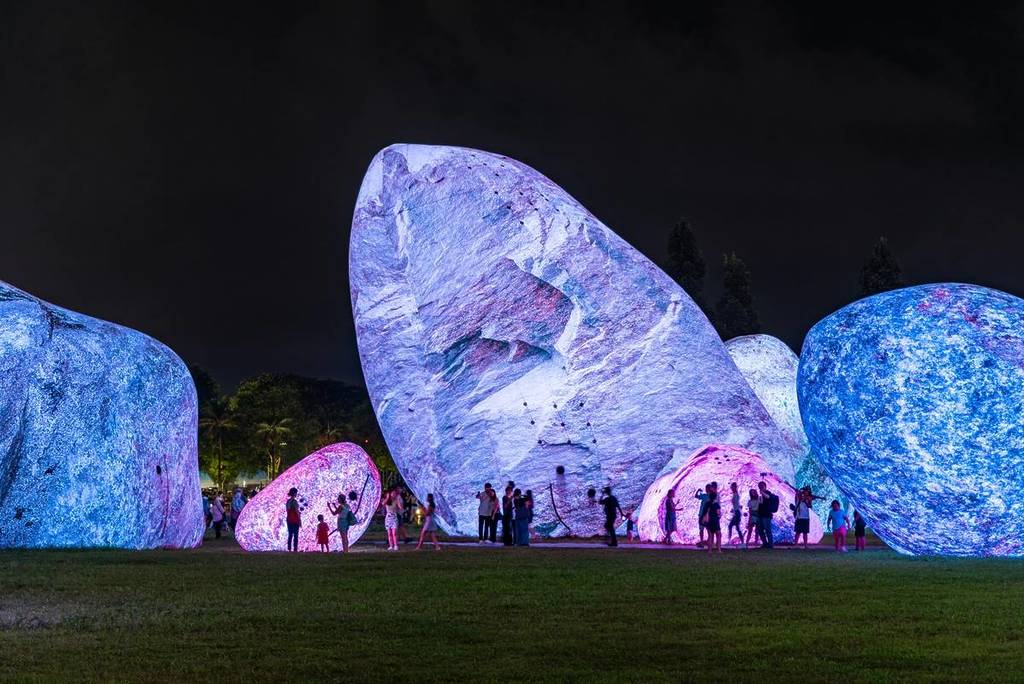 silhouettes of people against the glowing rock structures of Iwagumi Air Scape