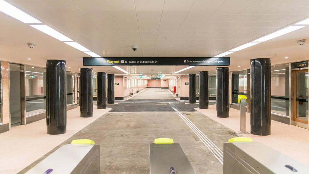 inside the reopened Campbell Arcade, with myki machines, pink walls and black pillars