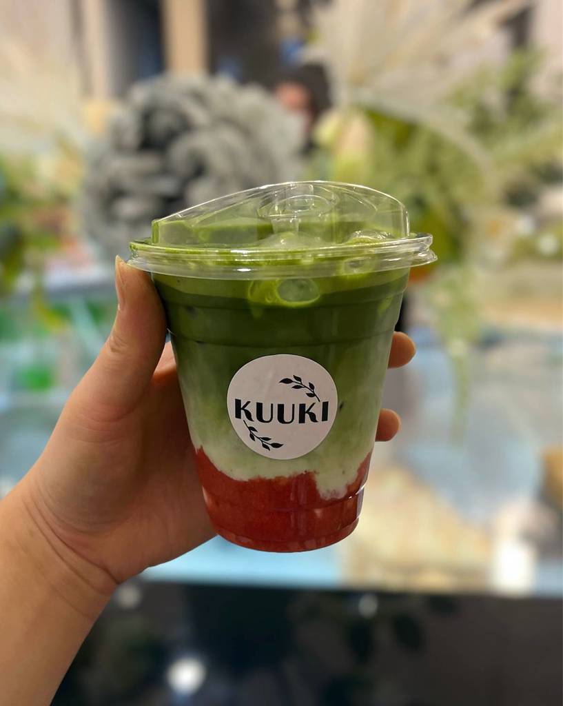 hand holding up matcha drink from Kuuki