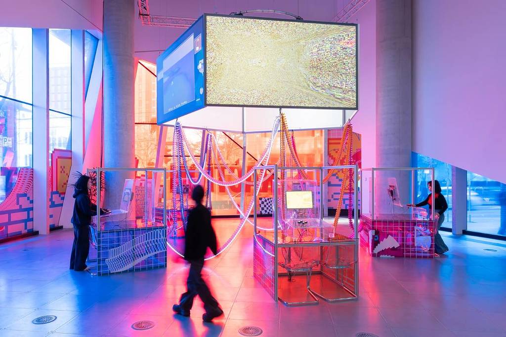 people exploring the custom arcade machines at Distraction exhibition in Science Gallery Melbourne