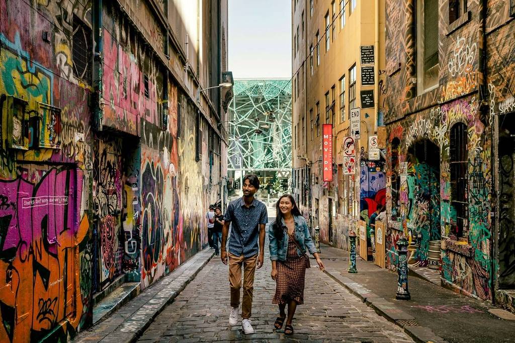 a couple walking down Hosier Lane