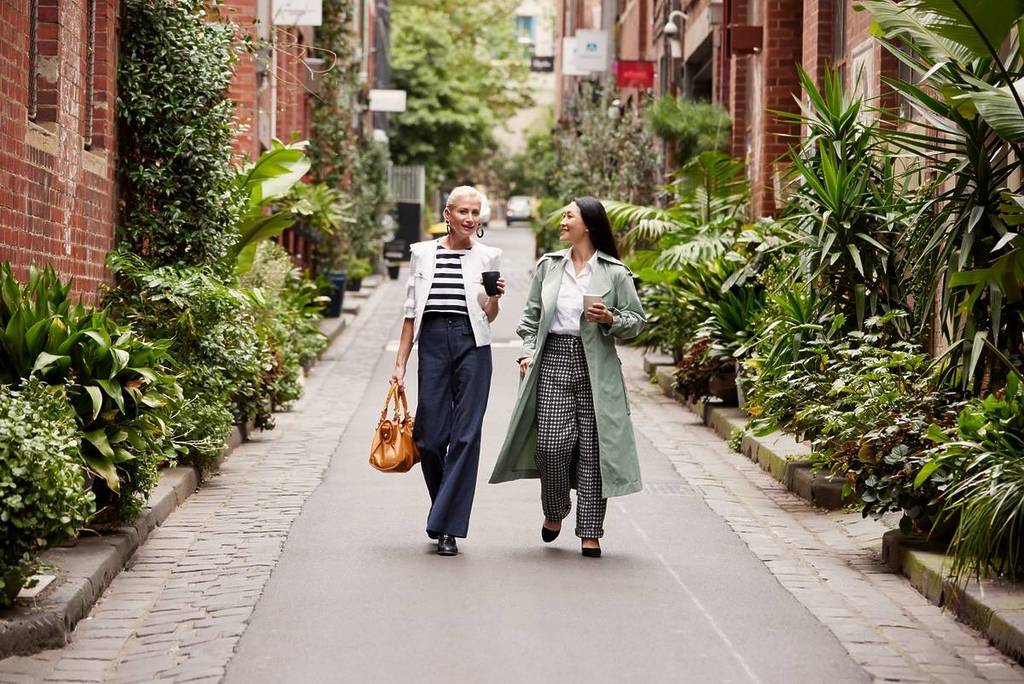 two women walking down the leafy Guildford Lane