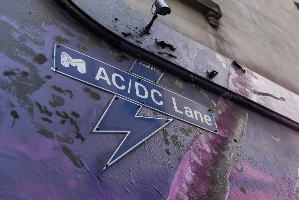 the sign for AC/DC Lane with a lightning bolt