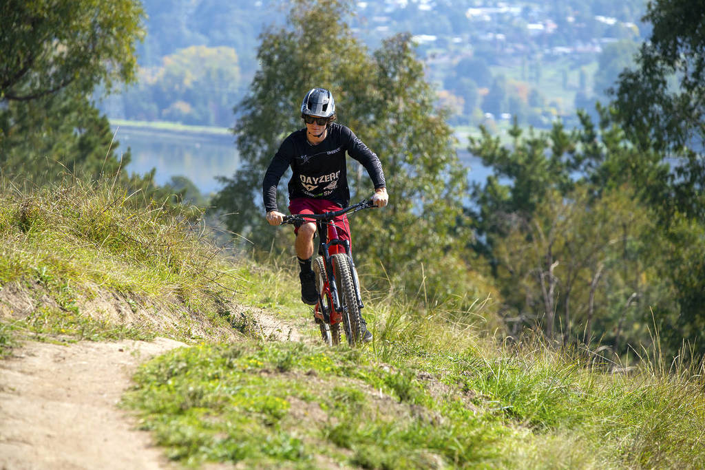 man riding mountain bike on Big Hill Trail in the High Country not too far from Mount Beauty
