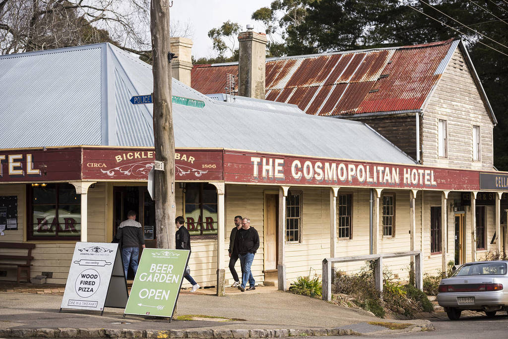 Cosmopolitan Hotel in Trentham, showcasing a rustic, vintage building with a welcoming beer garden and wooden signage, perfect for a cosy winter escape