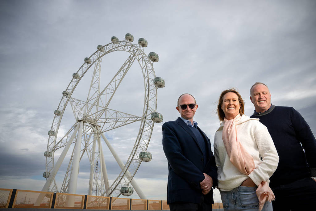 Jonathan Codman from The District Docklands and Jay and Jane Jones standing in front of Melbourne Star