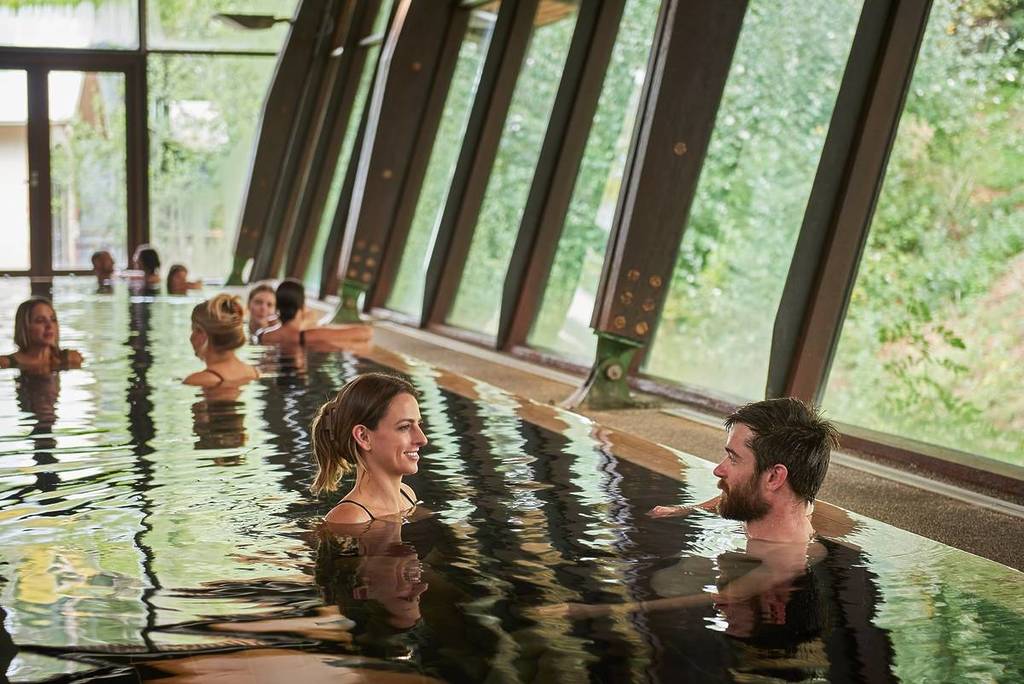 people chatting in the mineral water at Hepburn Bathhouse & Spa
