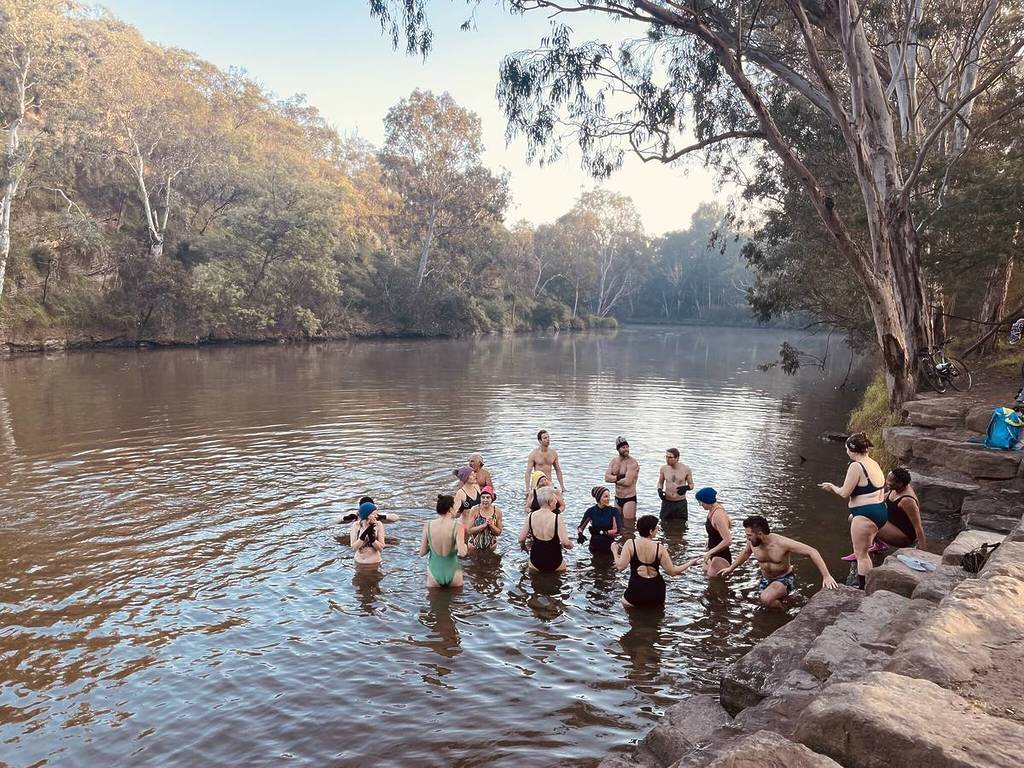 people standing in the Yarra River/Birrarung about to swim in a gathering for Riverfest